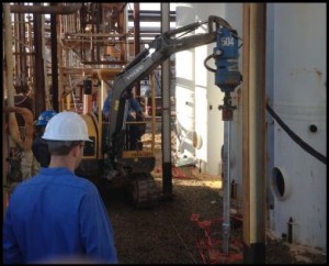 Installing pile under an existing pipe rack, between vessels, and with low clearance conduit.