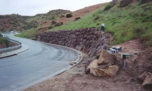 Rock Faced Retaining wall held with helical tie-backs